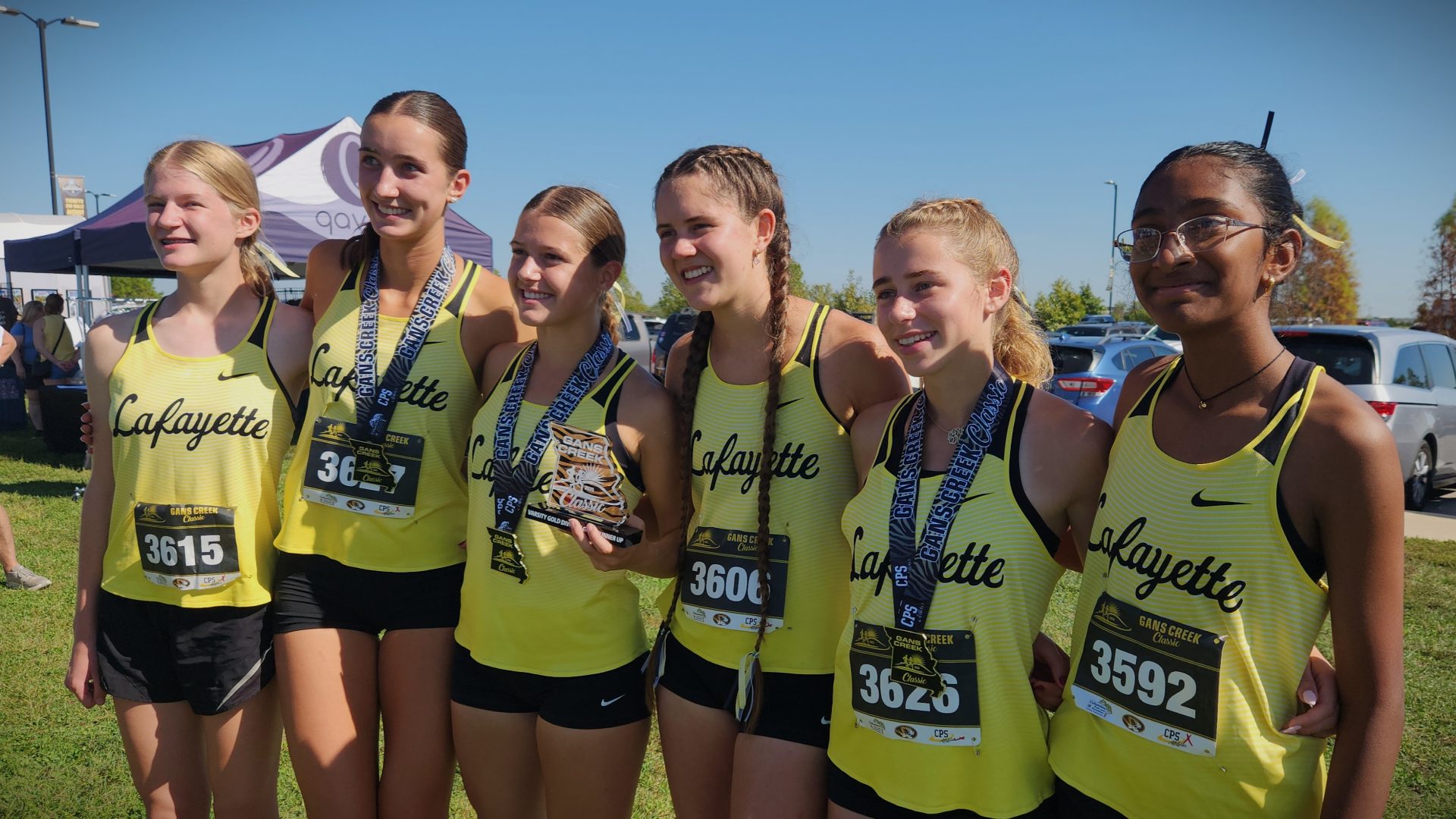 Kelly with cross country team at 2025 State