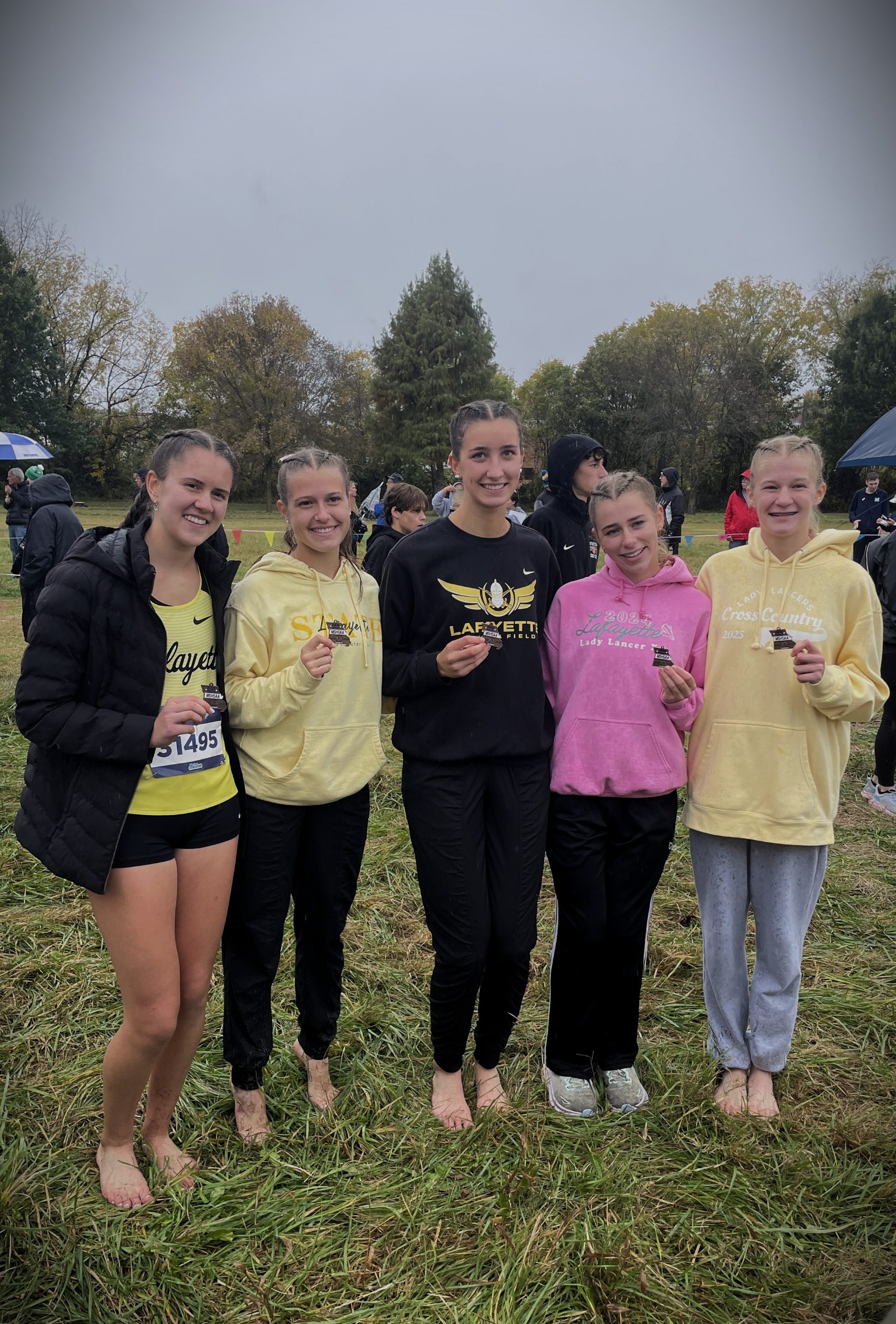 Kelly with cross country team at 2025 State